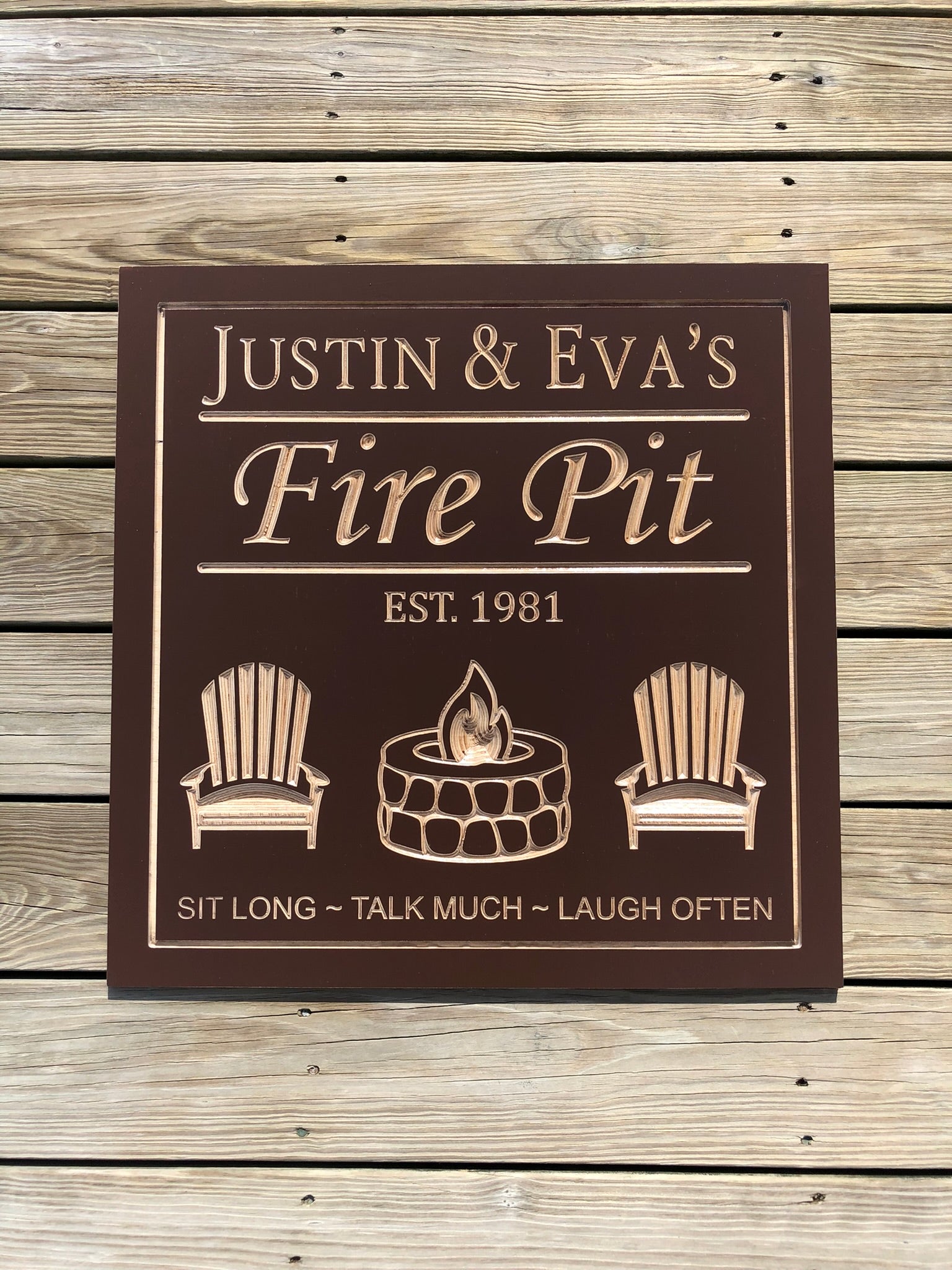 Personalized fire pit sign engraved with family name and established date, custom outdoor patio sign featuring Adirondack chairs, fire pit artwork, and backyard gathering decor by The Humble Chisel.